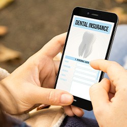 Looking at dental insurance form on smartphone