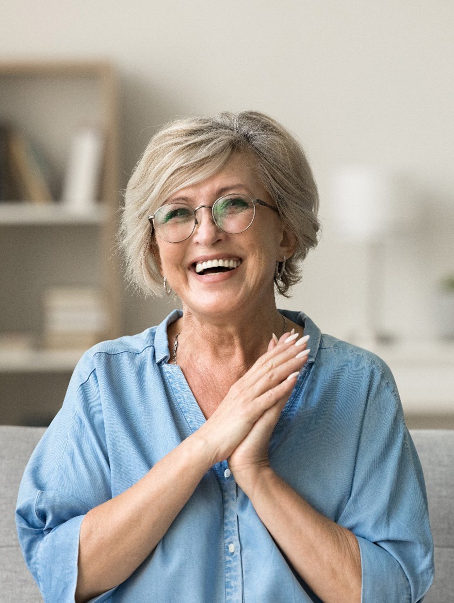 Woman in button-up shirt sitting on couch