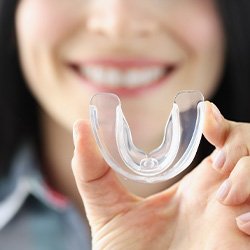 Woman holding a protective mouthguard