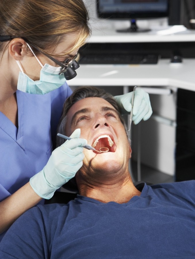 Dentist examining a patient's mouth